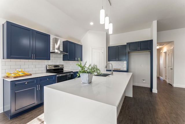 kitchen featuring stainless steel electric range oven, sink, wall chimney exhaust hood, backsplash, and a kitchen island with sink