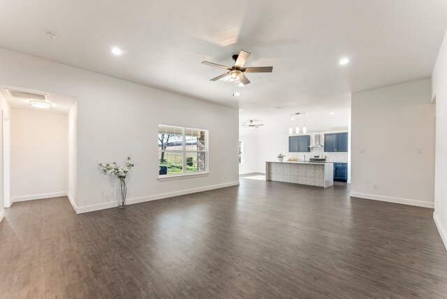 unfurnished living room with ceiling fan and dark wood-type flooring