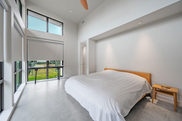 bedroom with a towering ceiling and ceiling fan