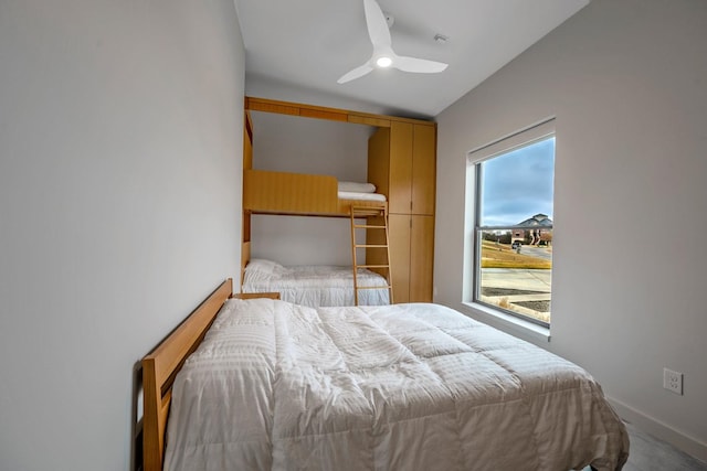 carpeted bedroom featuring ceiling fan and lofted ceiling