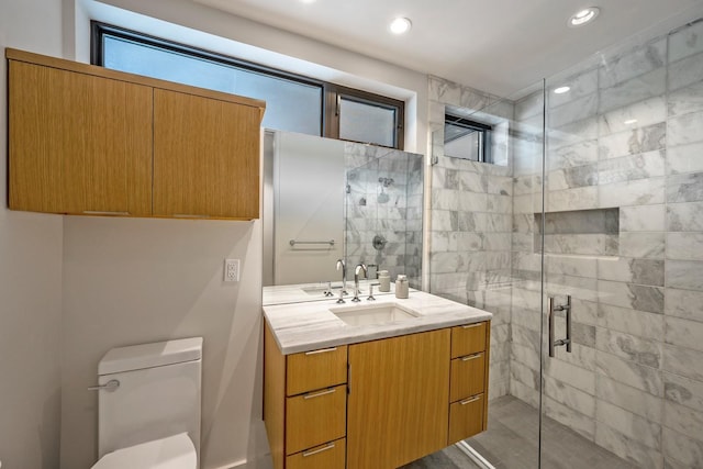 bathroom with vanity, toilet, and walk in shower