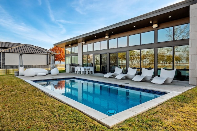 view of swimming pool with a patio area and a lawn