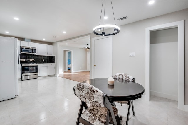 tiled dining area featuring ceiling fan