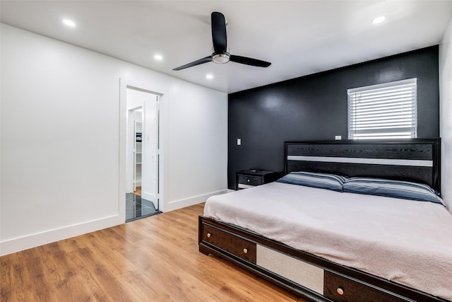 bedroom with ceiling fan and light wood-type flooring