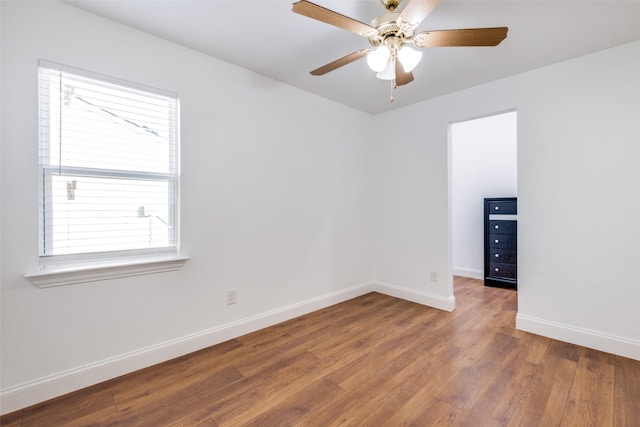 unfurnished room with hardwood / wood-style flooring and ceiling fan