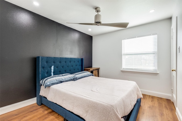 bedroom featuring light hardwood / wood-style floors and ceiling fan