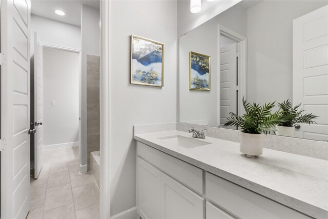 bathroom with tile patterned flooring and vanity