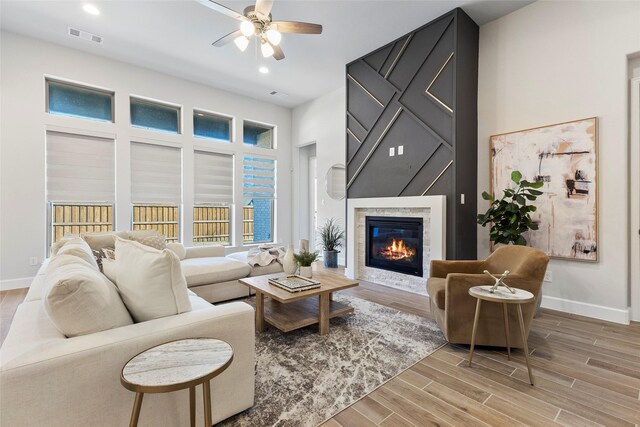 living room with ceiling fan and wood-type flooring