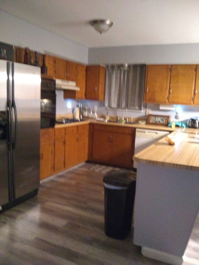 kitchen featuring sink, stainless steel fridge with ice dispenser, dark hardwood / wood-style flooring, white dishwasher, and oven