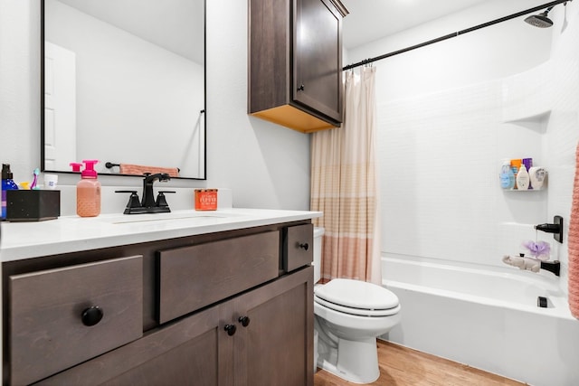 full bathroom featuring vanity, wood-type flooring, shower / tub combo, and toilet