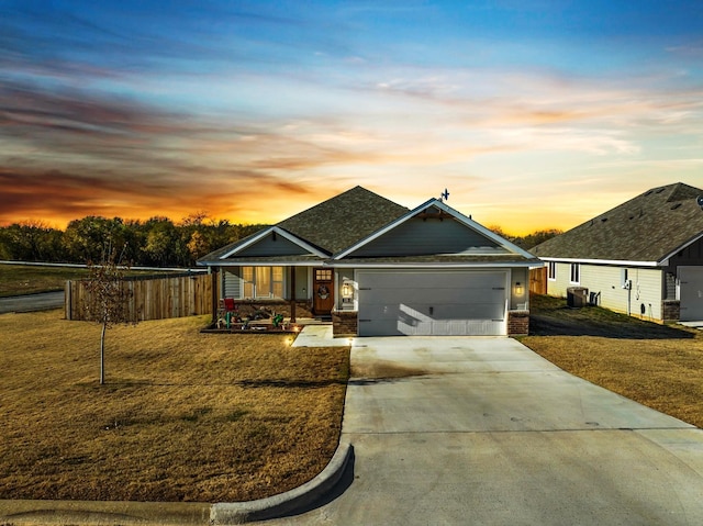 view of front facade with a yard and a garage