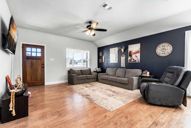 living room with light wood-type flooring, ceiling fan, and lofted ceiling