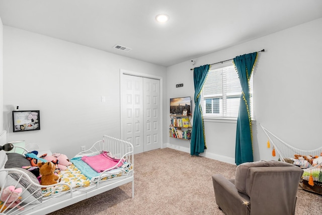 carpeted bedroom with a closet