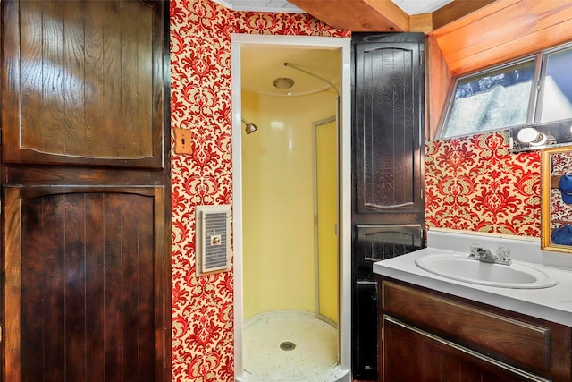 bathroom featuring walk in shower and vanity