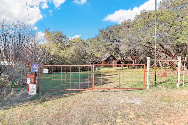 view of gate featuring a lawn