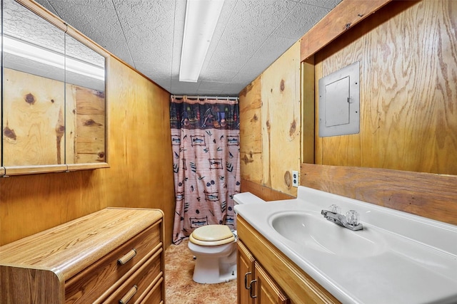 bathroom featuring vanity, curtained shower, toilet, and wood walls