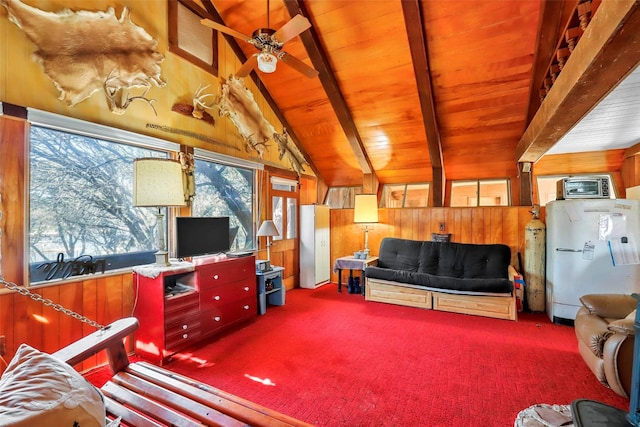 carpeted living room featuring wooden walls, lofted ceiling with beams, and wooden ceiling