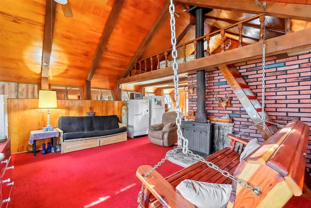 carpeted living room with vaulted ceiling with beams, wood ceiling, wooden walls, and a wood stove