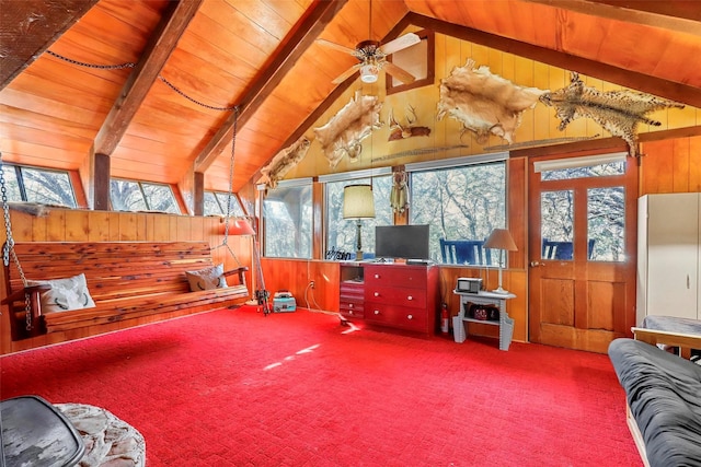 carpeted living room featuring wood ceiling, ceiling fan, wooden walls, and lofted ceiling with beams