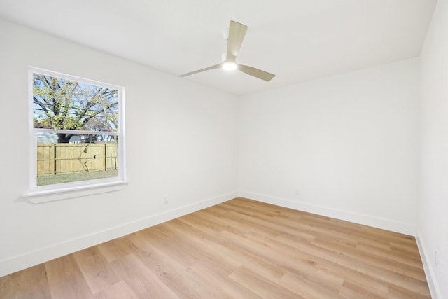 spare room featuring wood-type flooring and ceiling fan