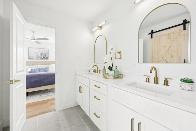 bathroom with hardwood / wood-style flooring, ceiling fan, and vanity