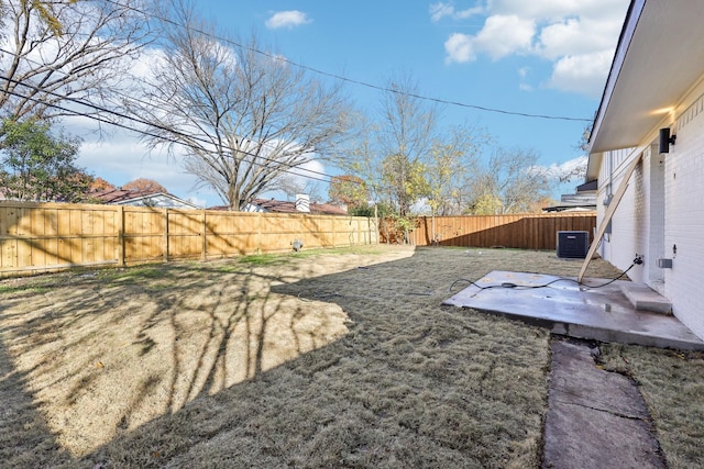 view of yard with cooling unit and a patio area