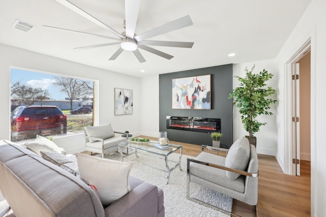 living room with hardwood / wood-style flooring and ceiling fan