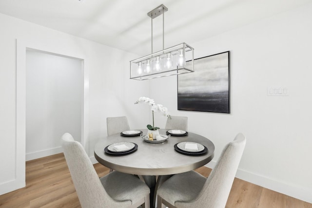 dining space with hardwood / wood-style flooring