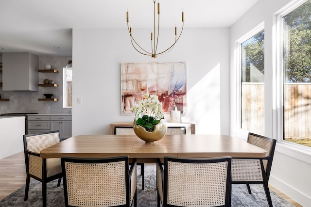 dining area with an inviting chandelier and light wood-type flooring