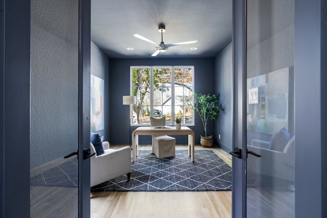 home office with hardwood / wood-style floors, french doors, and ceiling fan