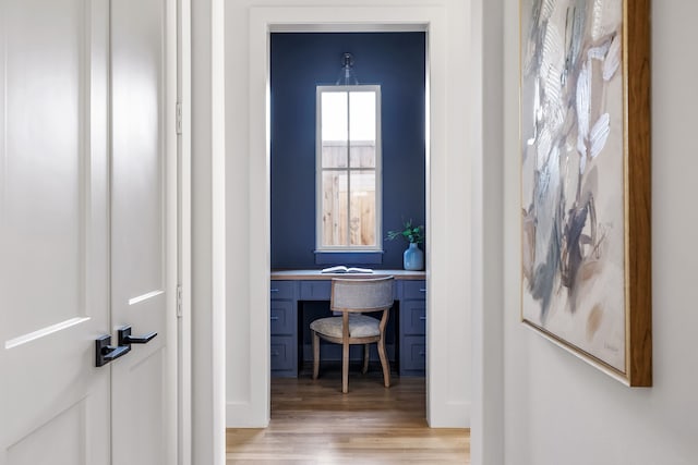 corridor with light hardwood / wood-style flooring