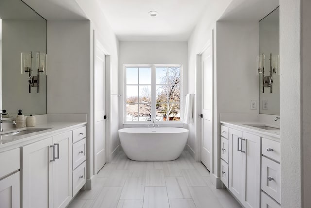 bathroom with vanity and a bath