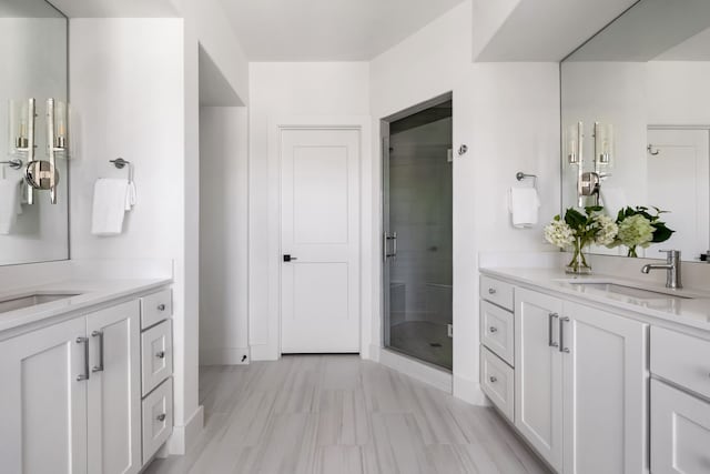 bathroom featuring vanity and a shower with door