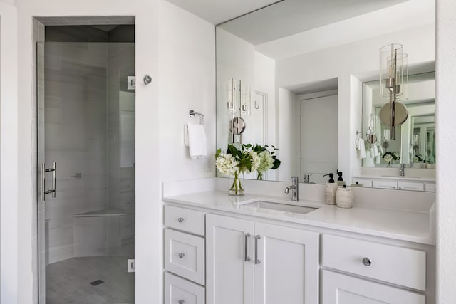 bathroom with vanity and a shower with shower door