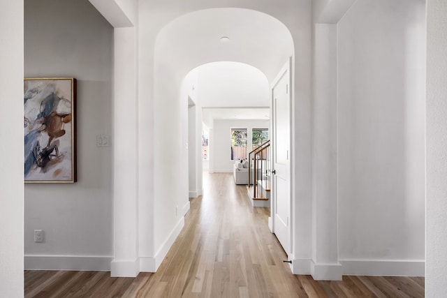 corridor with light hardwood / wood-style floors