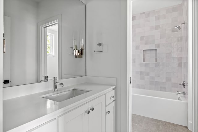 bathroom with vanity, tiled shower / bath combo, and tile patterned floors