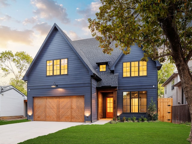 view of front of home with a yard and a garage