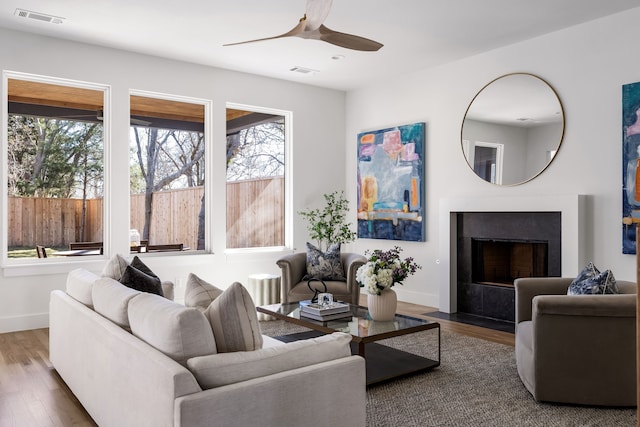 living room with ceiling fan and hardwood / wood-style floors