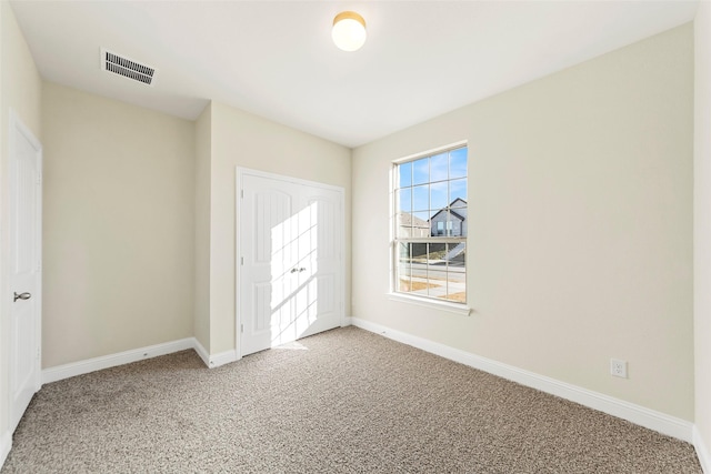 unfurnished bedroom featuring a closet and carpet