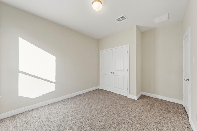 unfurnished bedroom featuring a closet and carpet