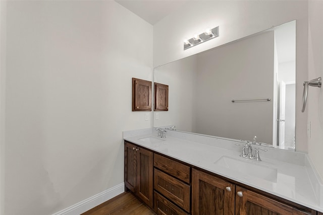 bathroom with hardwood / wood-style flooring and vanity