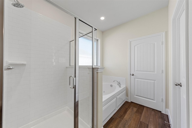 bathroom featuring hardwood / wood-style floors and shower with separate bathtub