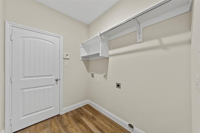 washroom featuring hookup for an electric dryer, wood-type flooring, gas dryer hookup, and washer hookup