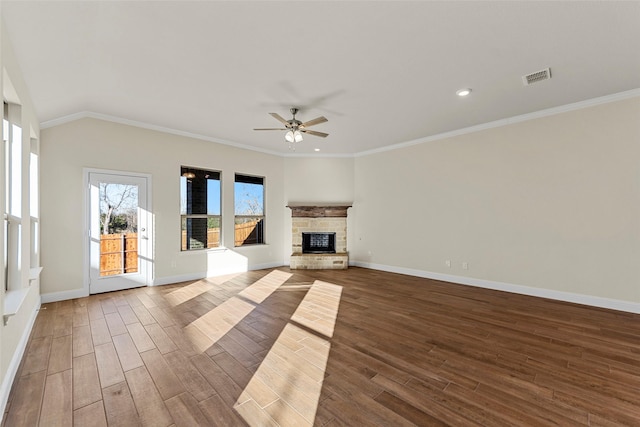 unfurnished living room featuring a fireplace, hardwood / wood-style flooring, ceiling fan, and crown molding