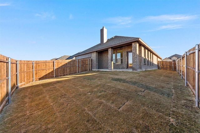 rear view of house with a yard