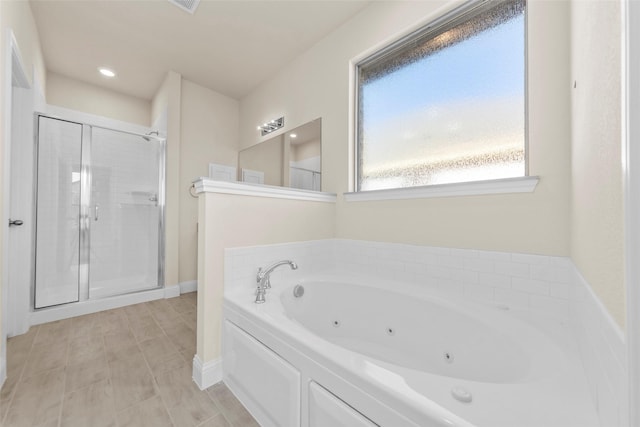 bathroom featuring separate shower and tub