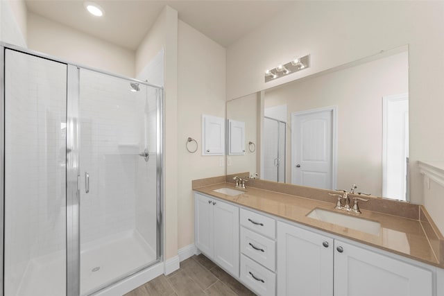 bathroom featuring vanity and an enclosed shower