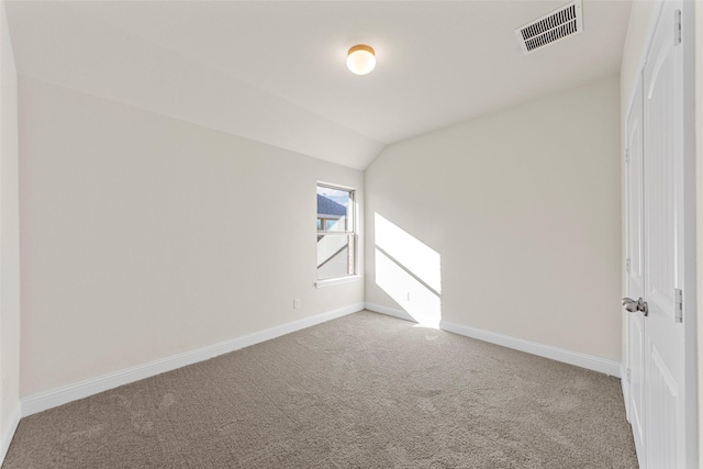 empty room with carpet and lofted ceiling