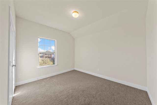 additional living space featuring carpet floors and vaulted ceiling