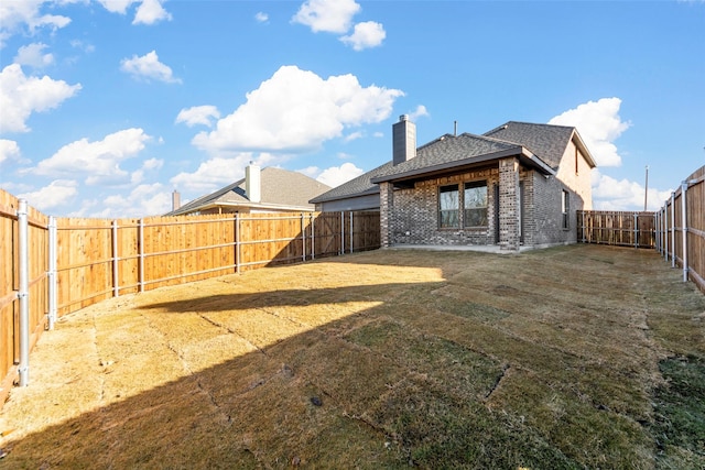 rear view of house with a yard and a patio